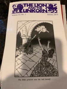 The cover of The Lion and the Unicorn January 2019 including a purple heading and a black and white illustration of two women tossing a child between them